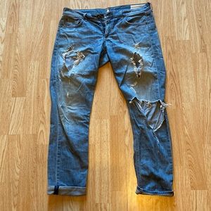 Ripped denim jeans, blue, good quality, slightly wrinkled. Bottom cuffs